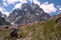 One of our porters rests with Shani Peak in the background.